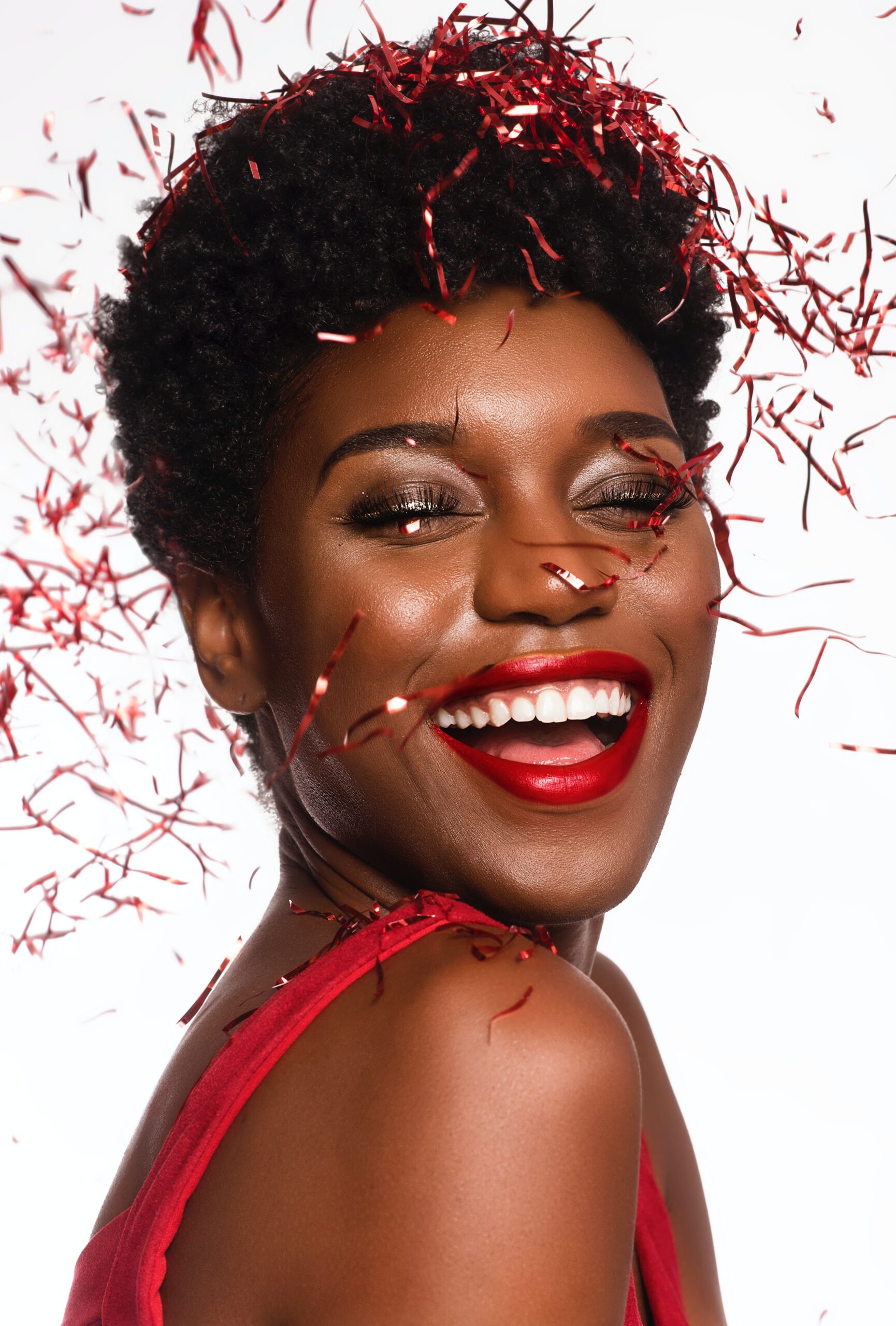 black woman celebrate red confetti